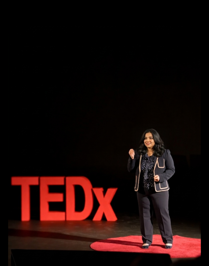 Madhuri Govindu speaking on the TEDx stage